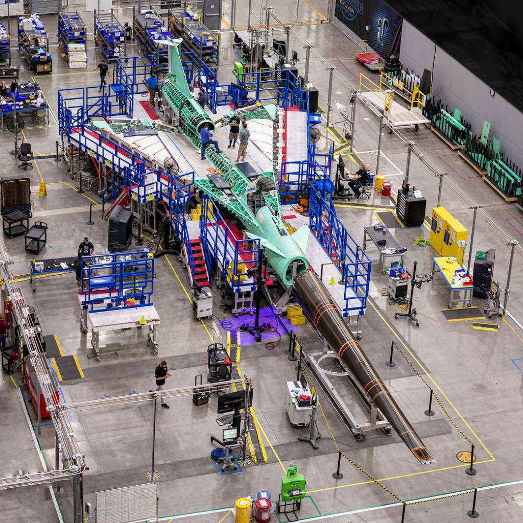 The X-59 Quiet SuperSonic Technology (QueSST) aircraft's nose is being attached to the front of the aircraft.