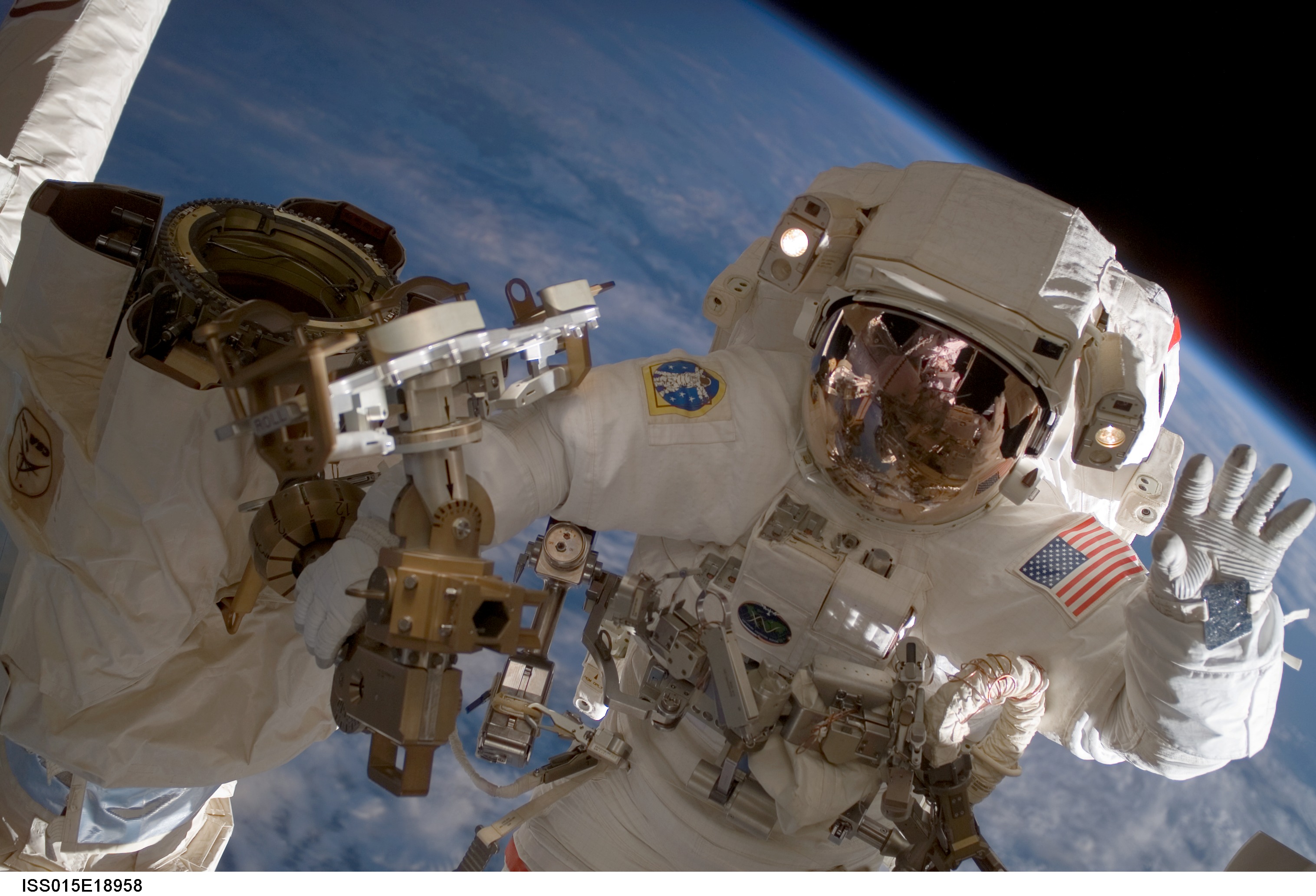 Astronaut Clay Anderson, Expedition 15 flight engineer, waves to the camera while participating in a session of extravehicular activity (EVA) as co...