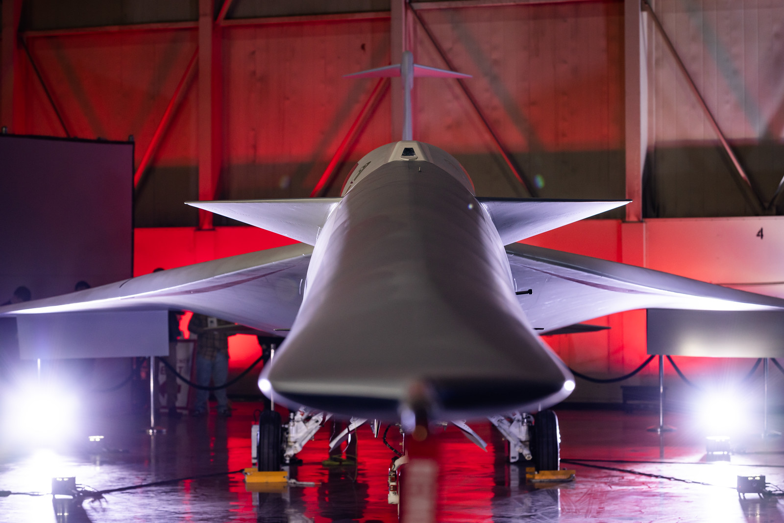 A front view of the X-59 airplane showcases its long, slender, and slightly flattened nose.