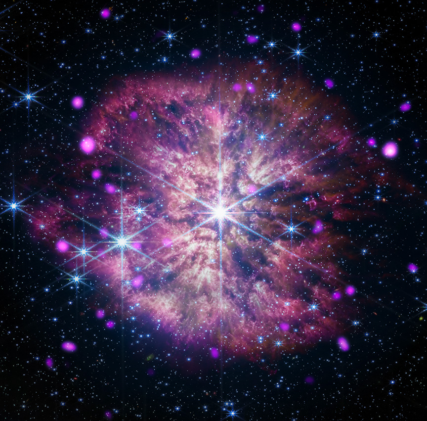 At the center of the composite image of WR124 is the large gleaming star in white and pale blue. The star sits at the heart of a mottled pink and gold cloud, its long diffraction spikes extending to the outer edges. Also residing in the cloud are other large gleaming stars, glowing hot-pink dots, and tiny specks of blue and white light.